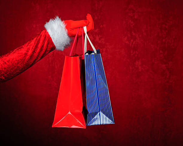 istock santa holding bags 185408221