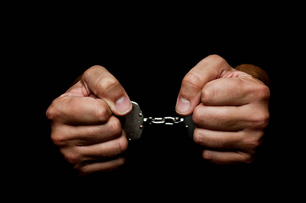 Handcuffes Handcuffes on man hand's on black background cuff stock pictures, royalty-free photos & images