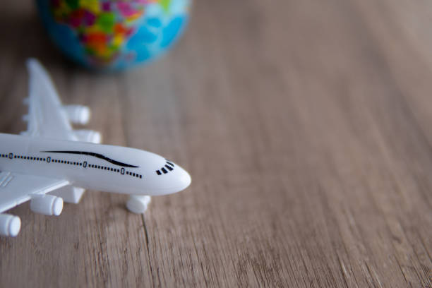 istock Closeup image of toy plane and earth globe on table with copy space. 1854152237