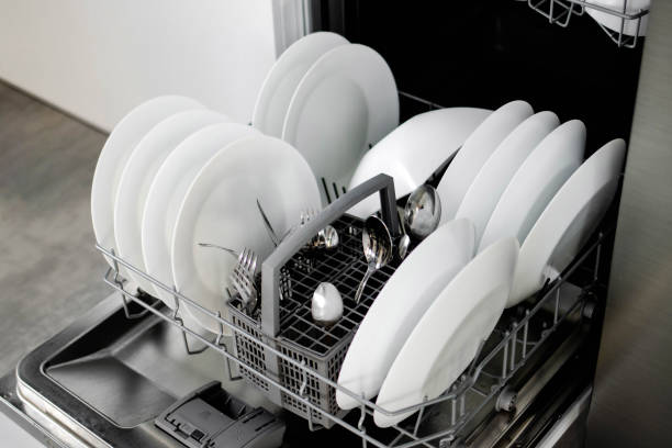 istock Built-in dishwasher. Clean dishes in the dishwasher. A clean white utensil. Modern technologies in the kitchen. Modern home kitchen. Housework 1854165364