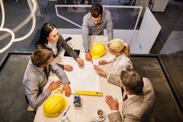 istock Above view of team of architects analyzing blueprints in the office. 1854174230