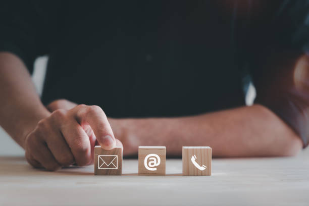 istock Contact us or Customer support hotline people connect. Businessman touching on virtual screen contact icons ( email, address, live chat, internet wifi ). 1854180008