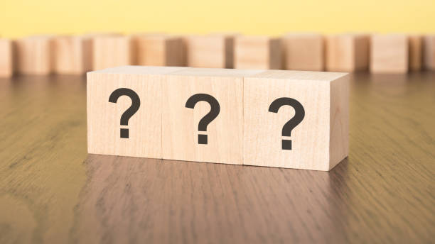 istock three question marks written on wooden cubes lying on table, business and education concept. close-up cubes 1854191042