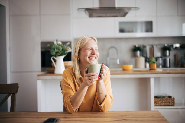 istock Young Caucasian albino woman enjoys in the kitchen while drinking coffe 1854217610