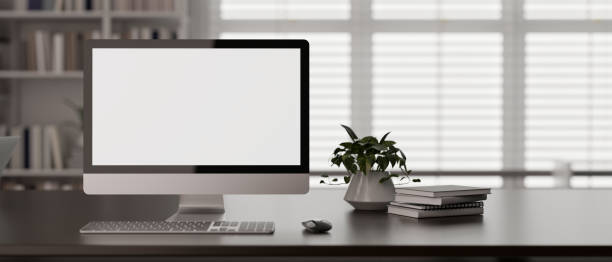 istock Front view of a modern workspace in a modern office room with a PC desktop computer mockup on a desk 1854225430