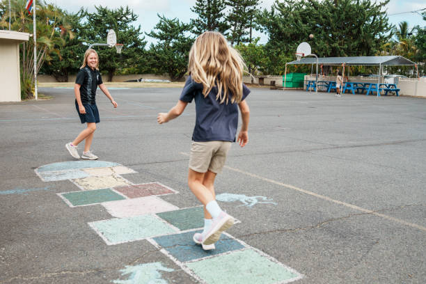 istock Two young girls play hopscotch outside 1854227002