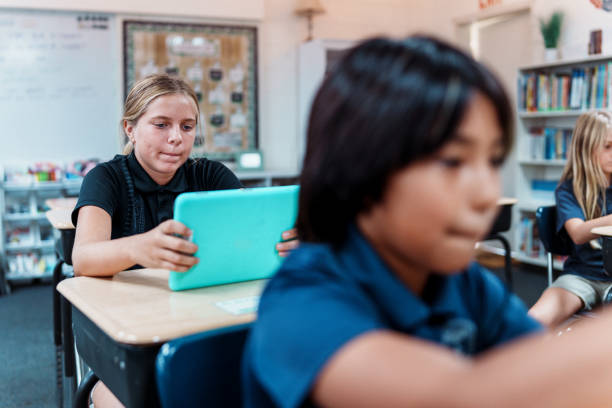 istock Young girl uses tablet during school work time 1854228091