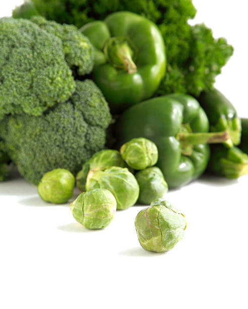Fresh green vegetables on a white background.