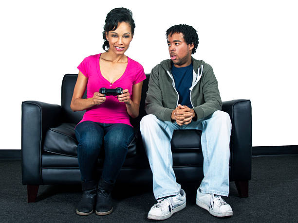 istock Young Couple Playing Video Games on a Couch 185423319