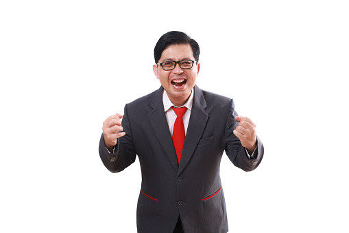 Happy successful asian businessman shouting with fist hands. Isolated on white background