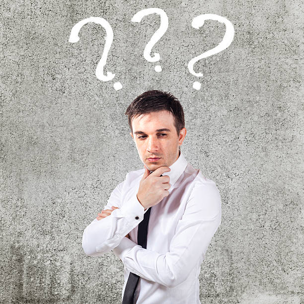 istock confused businessman on grunge background 185424201
