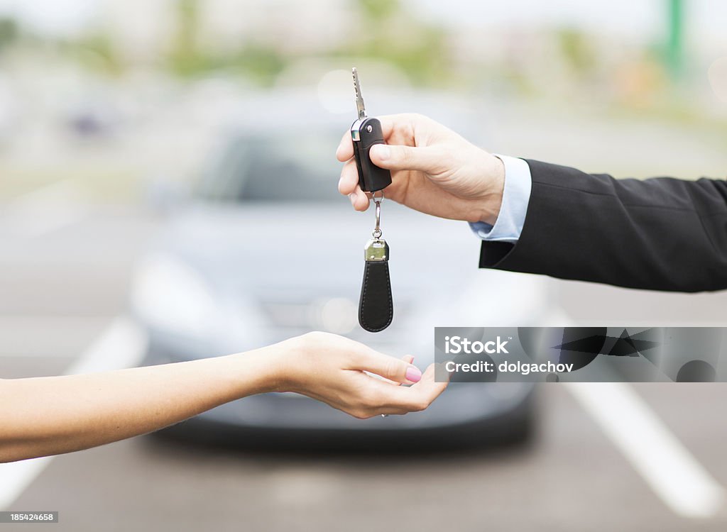 customer and salesman hands with car key transportation, business, rent and ownership concept - close up of customer and salesman hands with car key outside Adult Stock Photo