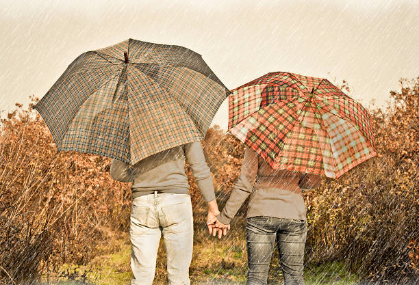 istock Young couple under an umbrella on the autumn rain. 185424901