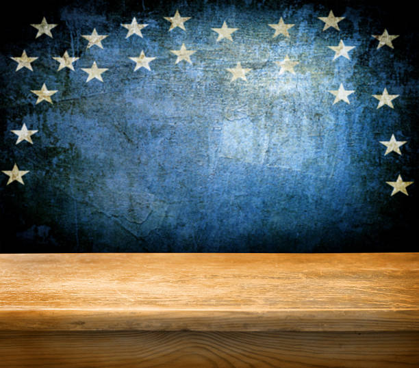 Empty wooden table over a blue background with stars Empty wooden deck table with tablecloth for USA holidays background montages patriotic quilt stock pictures, royalty-free photos & images