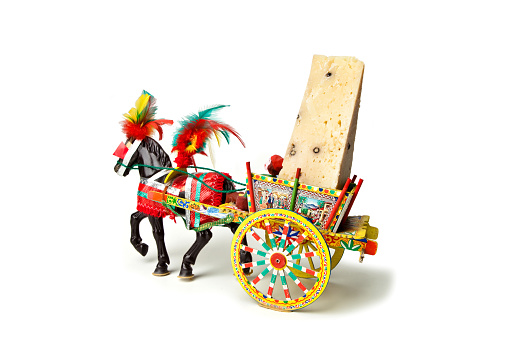 Traditional Sicilian cart, transporting a piece of typical Sicilian cheese, isolated on white background