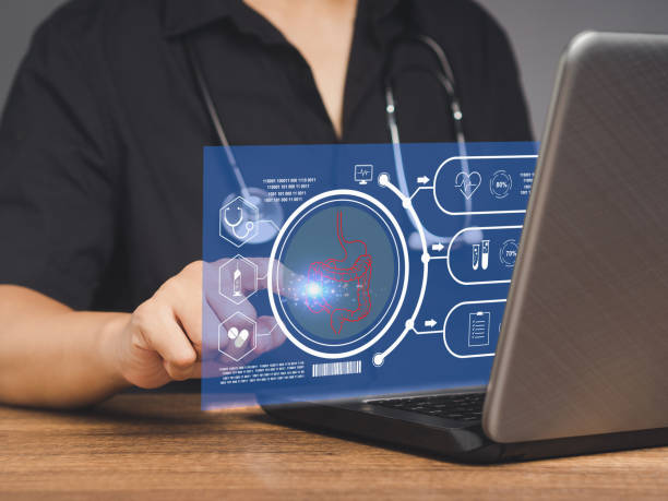 istock Doctor read a report on an intestine patient checkup on a virtual screen while sitting at the table. 1854257520