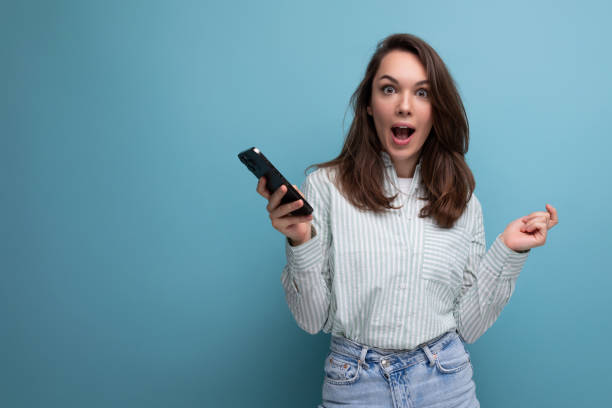 istock charming brunette young lady uses smartphone to communicate online 1854278759