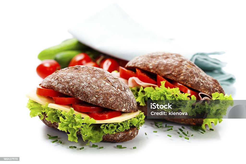 sandwiches Grain bread sandwiches with ham,cheese and fresh vegetables over white - healthy eating concept Baguette Stock Photo