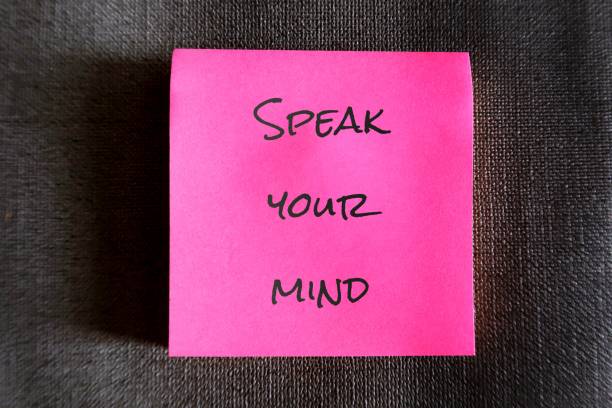 istock Pink note with text handwriting SPEAK YOUR MIND, self reminder to be true to yourself, express feelings or opinions frankly , say what you think without fear 1854282478
