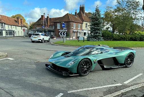 Beaconsfield, Buckinghamshire - October 14, 2023: The spectacular Aston Martin Valkyrie, as spotted driving around the roundabout in Beaconsfield Old Town. The Valkyrie is a limited production hybrid sports car, a collaboration between Aston Martin, Red Bull Racing Advanced Technologies and various others.