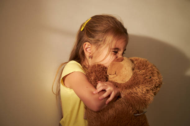 istock Beautiful girl hugging her Teddy Bear 1854301882