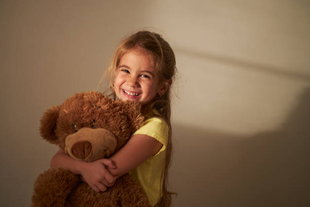 istock Beautiful girl hugging her Teddy Bear 1854304006