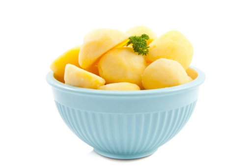 Bowl with cooked potato isolated over white