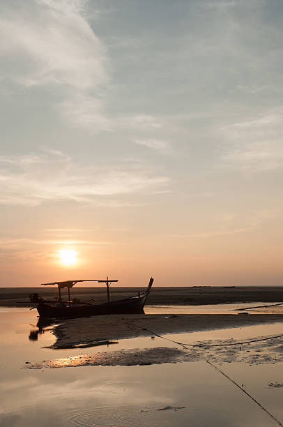 istock Fishing boat on a sea coast in morning 185431664