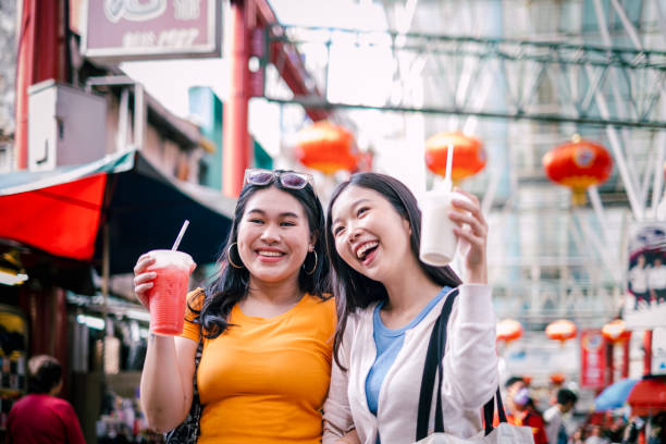 istock Two Beautiful Asian Woman Smiling While Enjoying Weekend Together. 1854319557