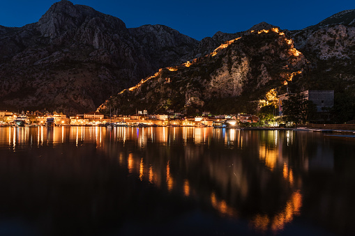 Town Kotor lights of city and reflection on a water withe the shaoe of heart during the evening, Montenegro.