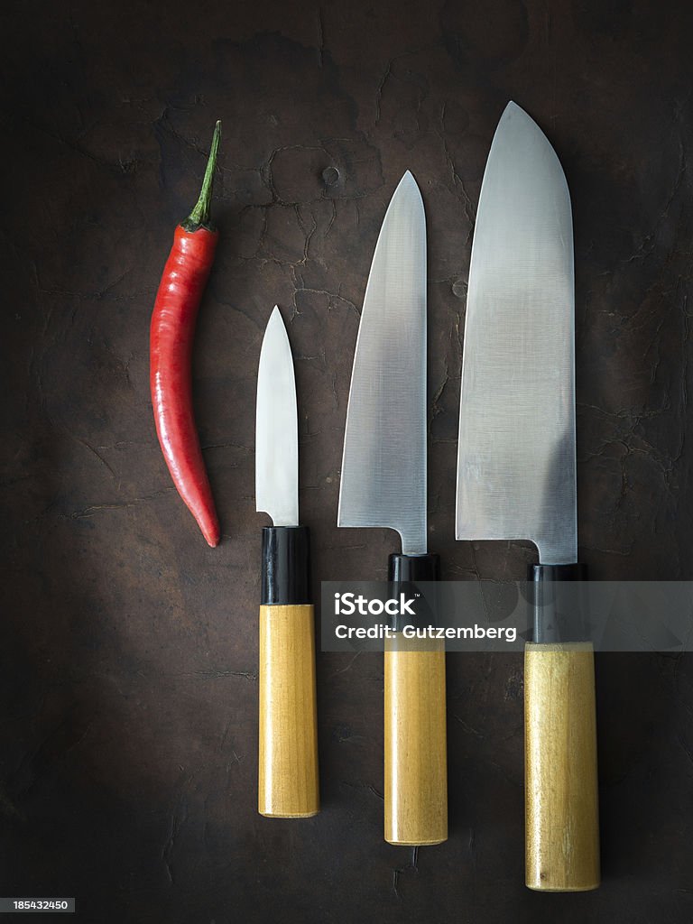 japanese Knife with Chili japanese Knife with Chili on old Leather Chef Stock Photo