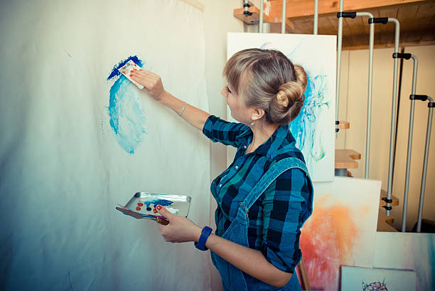 istock beautiful blonde woman painter 185432653