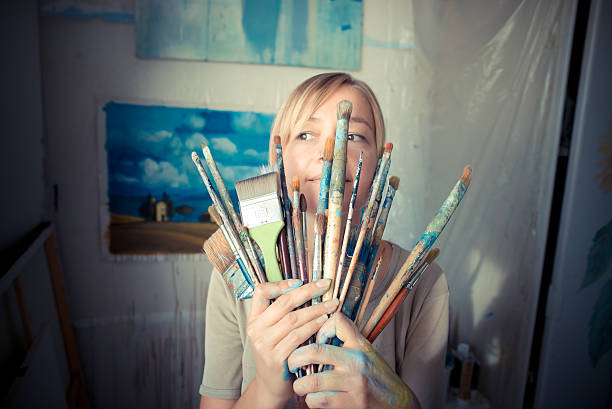 istock beautiful blonde woman painter 185432935