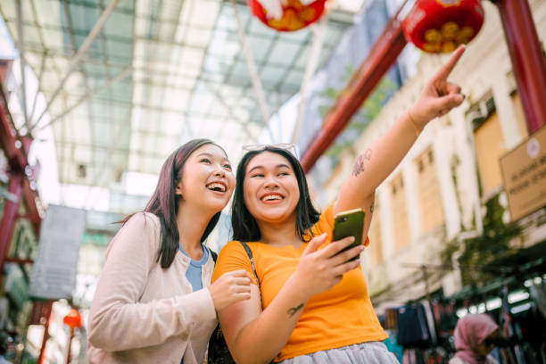 istock Happy Two Young Woman Travelling Together. 1854333859
