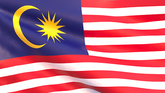 Two hands raised the flag and looking at camera. Celebrating Malaysia Independence Day \