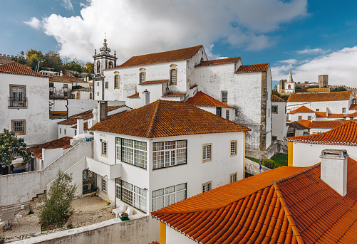 elevated view of a close up of tile roof tops of several buildings in the downtown area of Grazalema, Spain