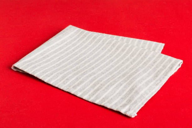 istock top view with gray kitchen napkin isolated on table background. Folded cloth for mockup with copy space, Flat lay. Minimal style 1854361958