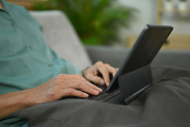 istock Cropped shot of middle age man working online or surfing internet on digital tablet 1854372089