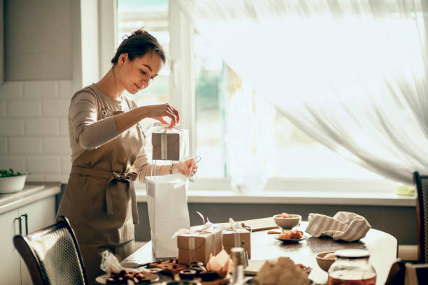 istock A female bakery owner packs boxes for a customer's order into a birthday, Christmas package. A small business entrepreneur and the concept of food delivery. 1854379106