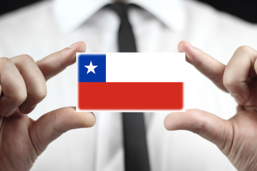 Businessman holding a business card with Chile Flag