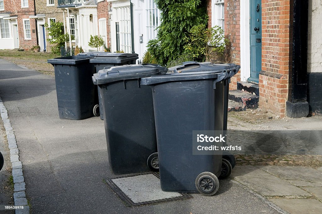 Bin Blight Wheelie bins obstructing a pavement in a village City Stock Photo