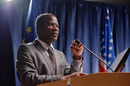 African American politics giving his speech in microphone during military conference