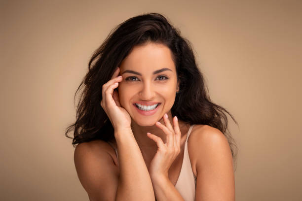 istock Sensual beautiful young brunette woman touching her face 1854408810