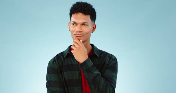 istock Thinking, confused and man doubt decision in studio isolated on a blue background mockup space. Solution, idea and person with question, contemplating and problem solving, planning choice or remember 1854414930