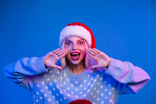 Photo of crazy cheerful girl wear trendy clothes ugly two hands near face mouth announcing sale isolated on blue color background.