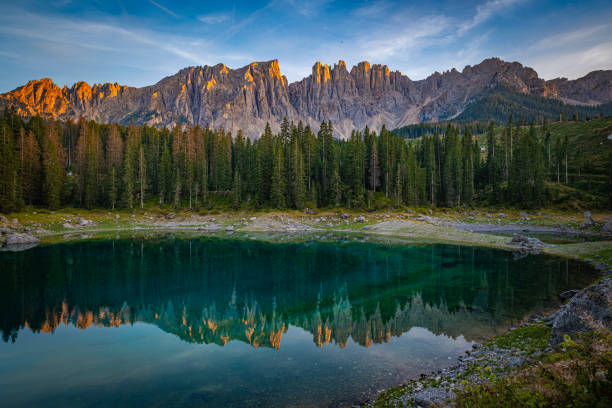 istock Lago di Carezza's emerald waters, misty forests, and Latemar views create an unparalleled Alpine charm 1854445503