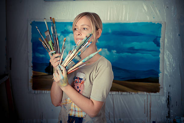 istock beautiful blonde woman painter 185444638
