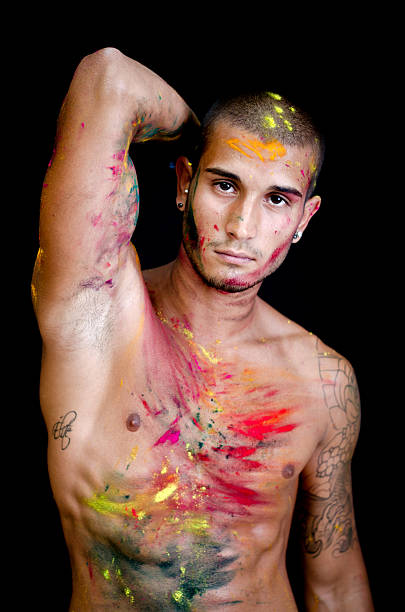 istock Handsome young man, skin all painted with Holi colors 185444713