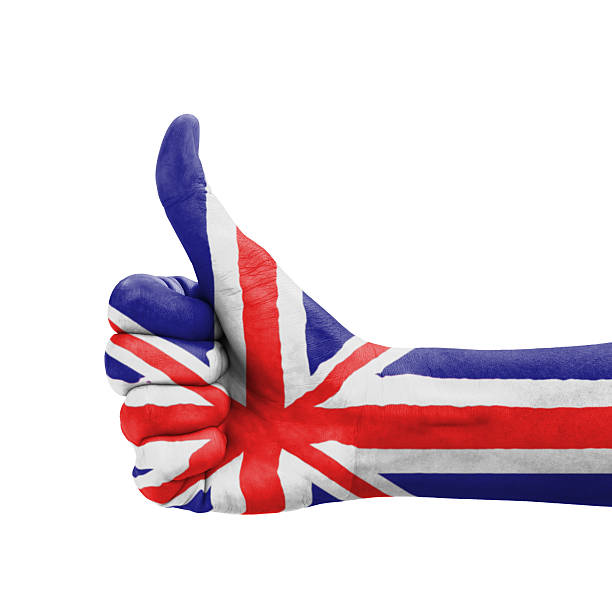 Hand with thumb up, UK (United Kingdom) flag painted stock photo