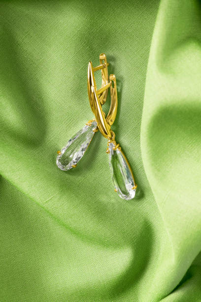 istock Golden earrings on fabric 1854452446